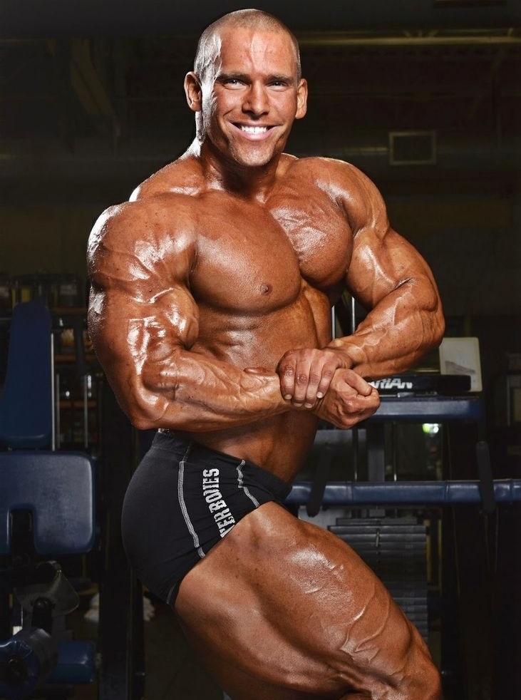 Jordan Janowitz doing a side chest pose in a photo shoot, looking big and muscular