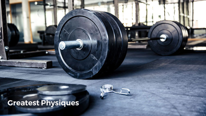 Barbells and weight plates on the floor of a crossfit gym