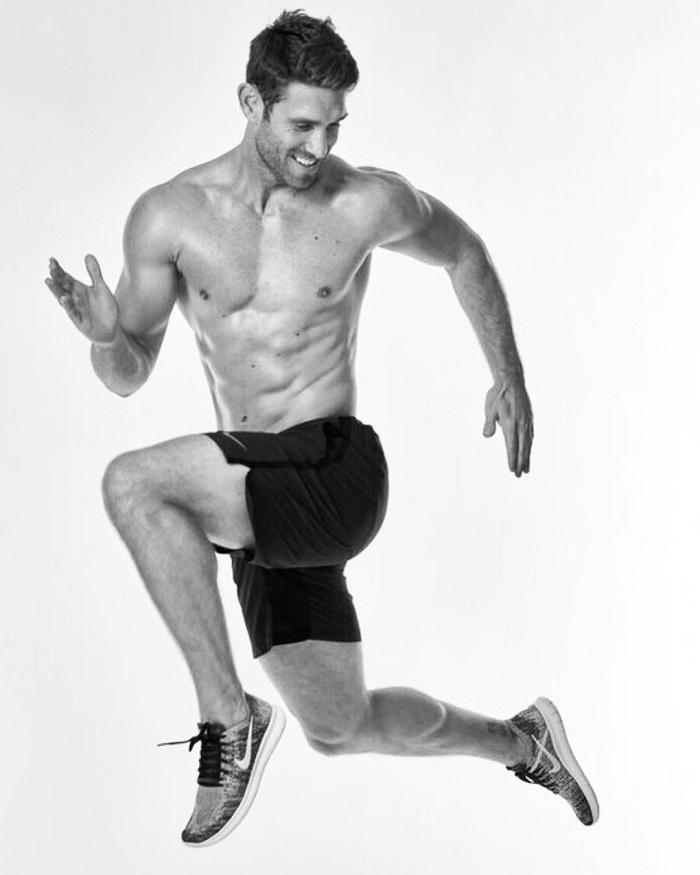 CJ Koegel in a running pose during a photo shoot looking fit and lean