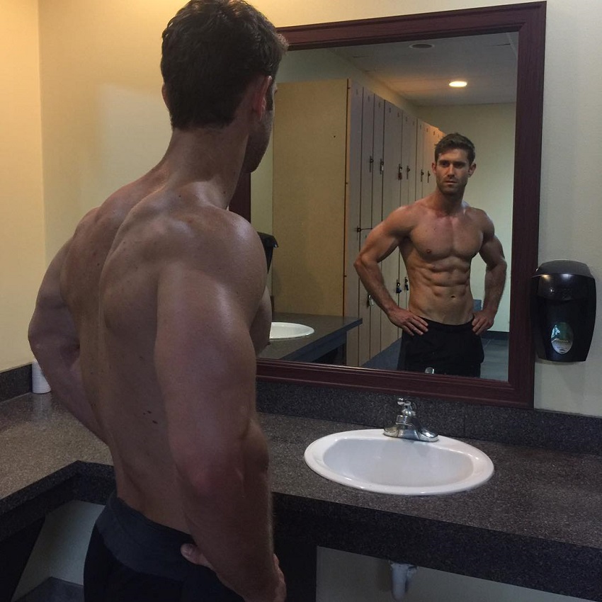 CJ Koegel looking at his big and ripped muscles in the mirror