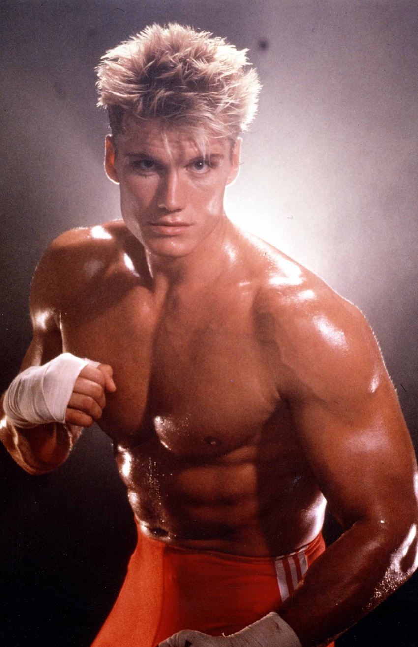 Dolph Lundgren standing shirtless in a boxing stance looking lean and muscular