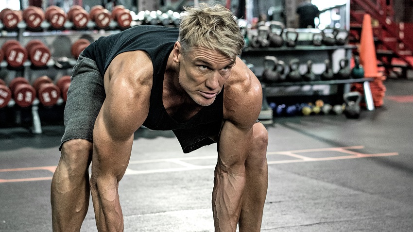 Dolph Lundgren training heavy in a gym looking strong and fit