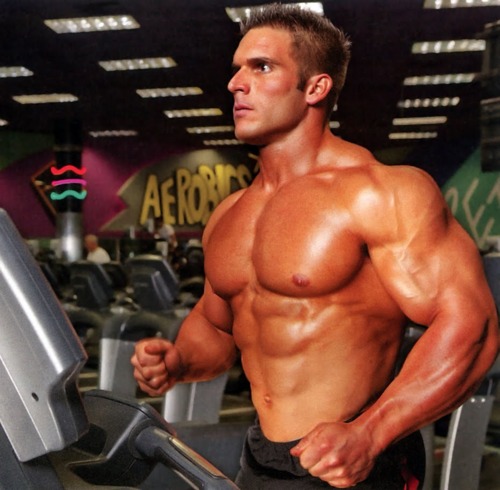 Josh Bergeron shirtless on a treadmill machine looking ripped