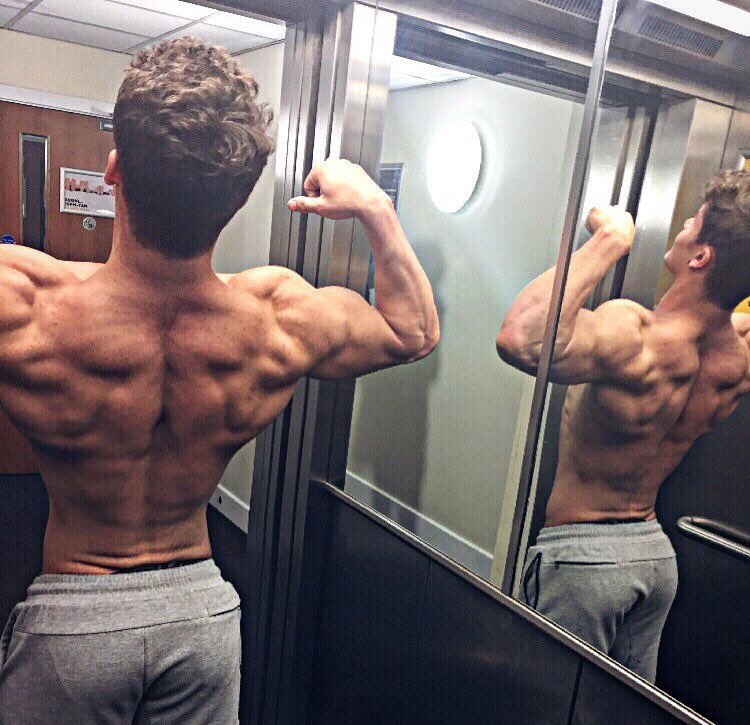 Justin Martilini flexing his shirtless back muscles looking fit and ripped