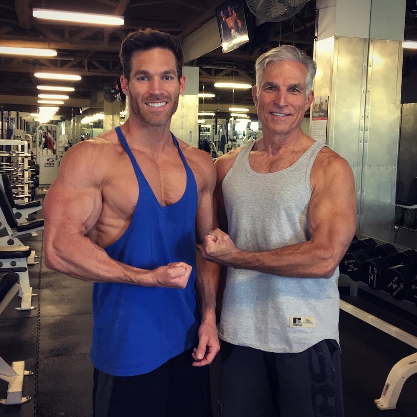 Kyle Clarke flexing his biceps with his dad