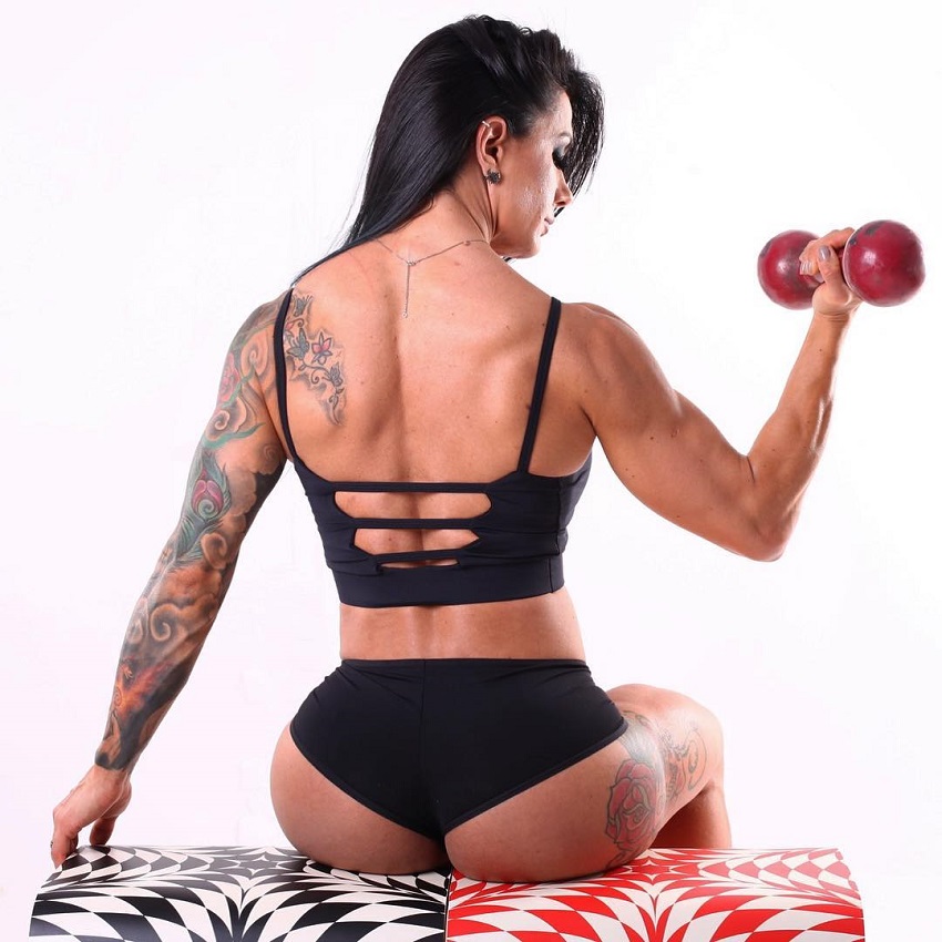 Renata Costa lifting a dumbbell looking fit and lean from the back