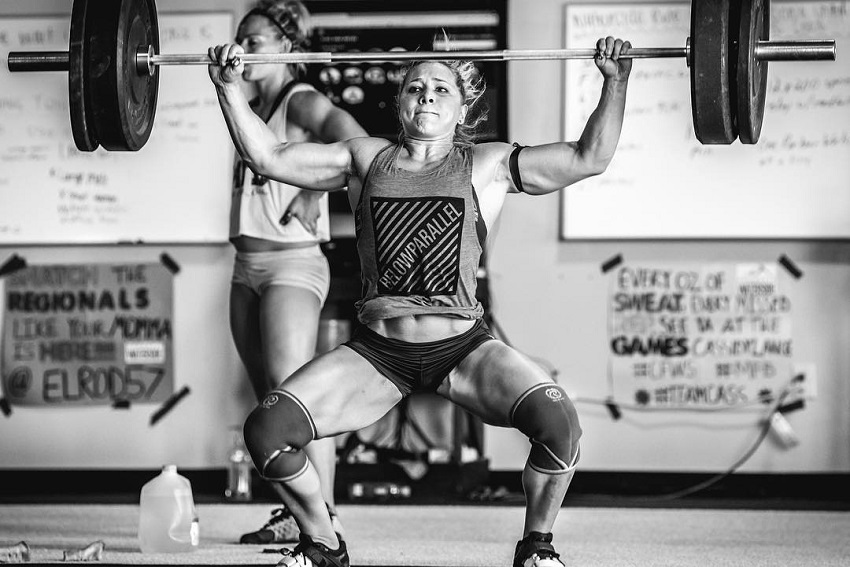 Alexis Johnson doing a heavy overhead press during CrossFit training