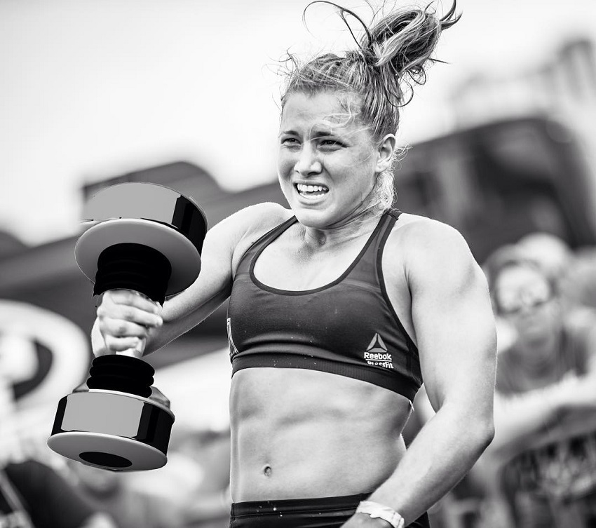Alexis Johnson lifting a heavy dumbbell during a CrossFit competition