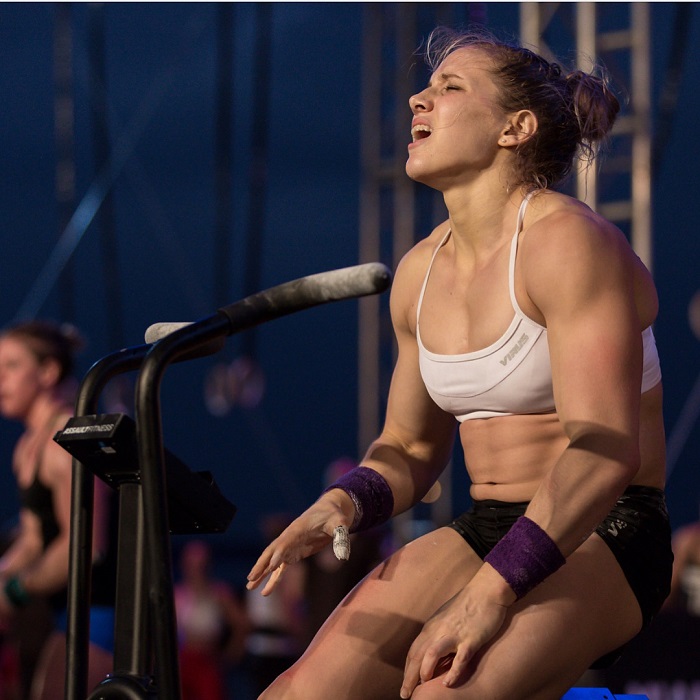 Alexis Johnson sitting during a CrossFit contest with a pained expression on her face