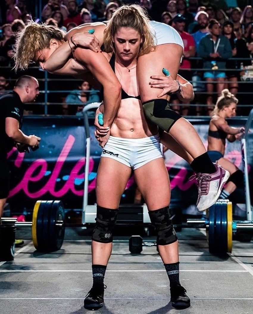 Alison Scudds carrying another CrossFit athlete during a competition