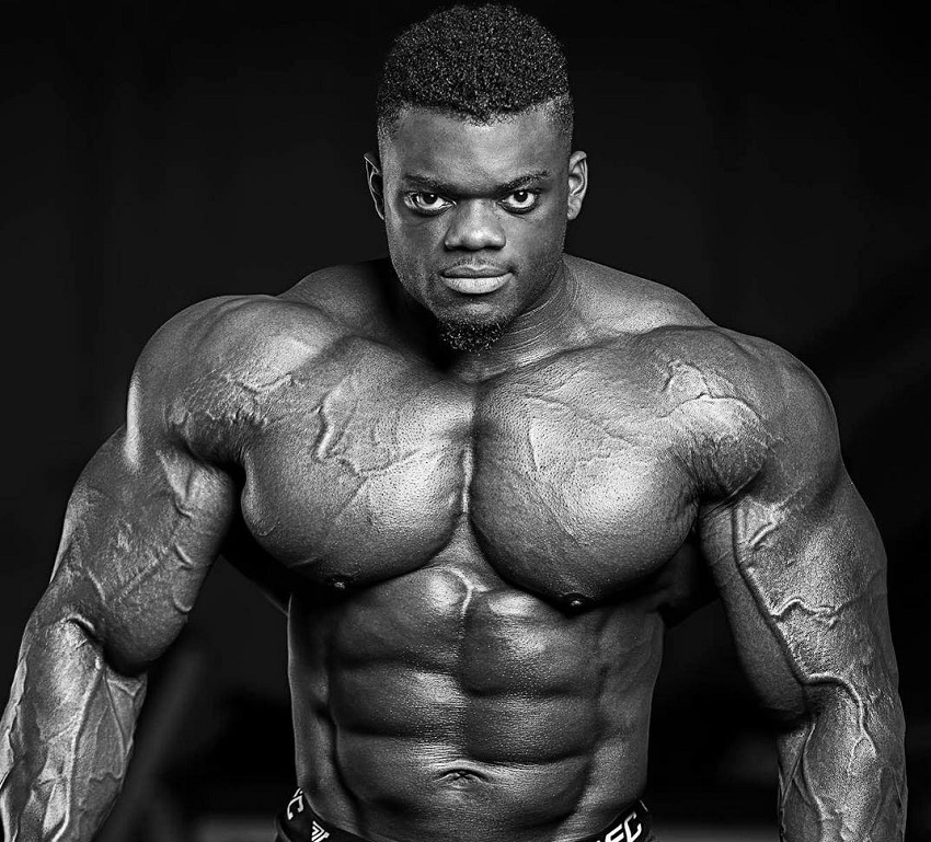 Blessing Awodibu posing shirtless in a photo shoot, looking huge and ripped