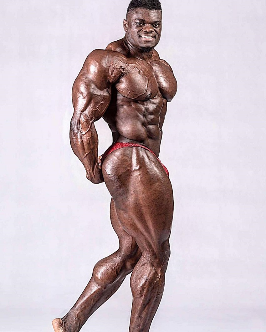 Blessing Awodibu doing a side triceps pose in a professional photo shoot