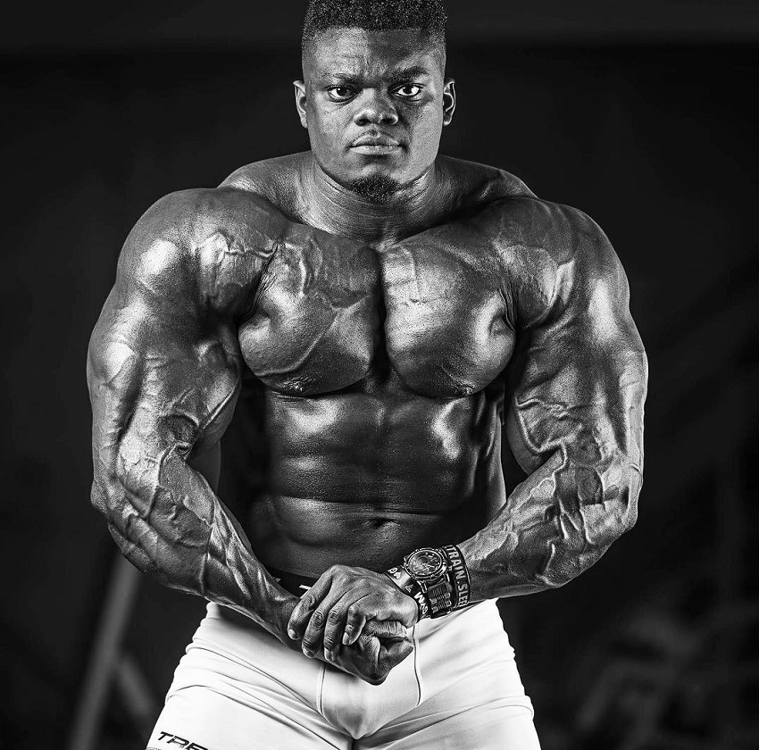 Blessing Awodibu flexing his arms chest and abs in a photo shoot