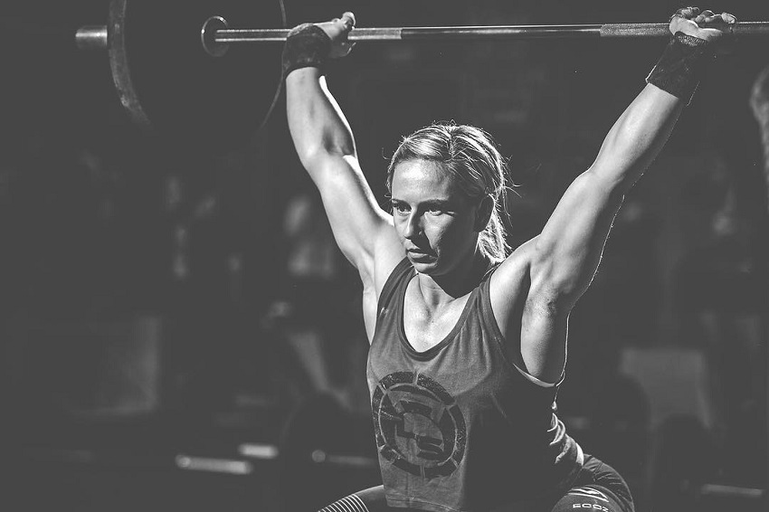 Cassidy Lance-Mcwherter lifting a heavy barbell during a photo shoot