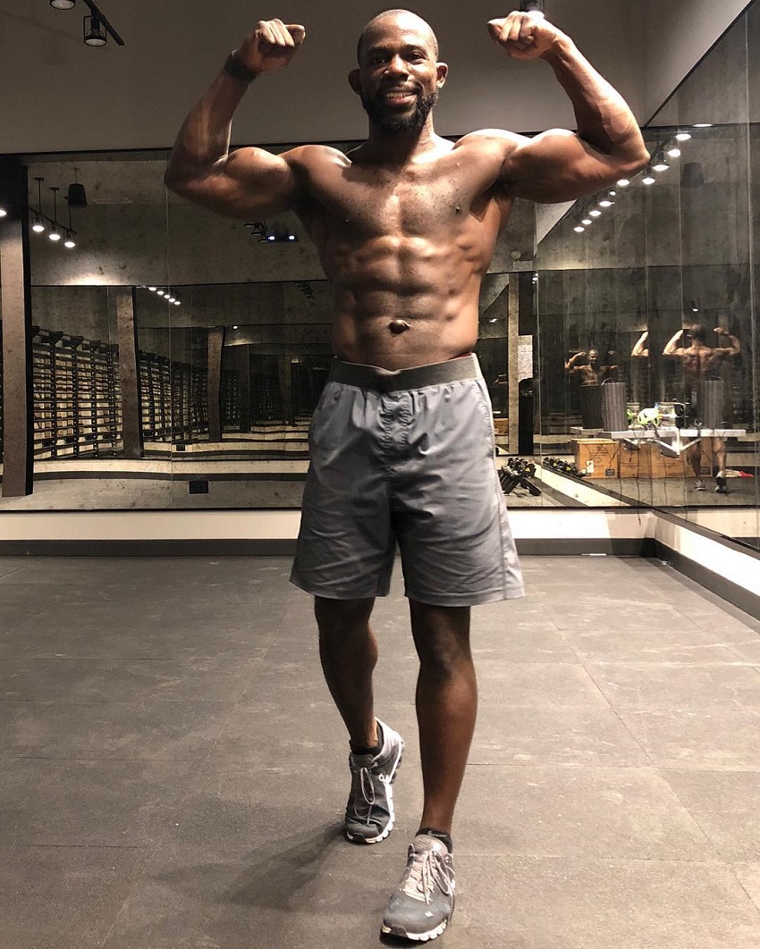 Gideon Akande flexing his biceps for a photo