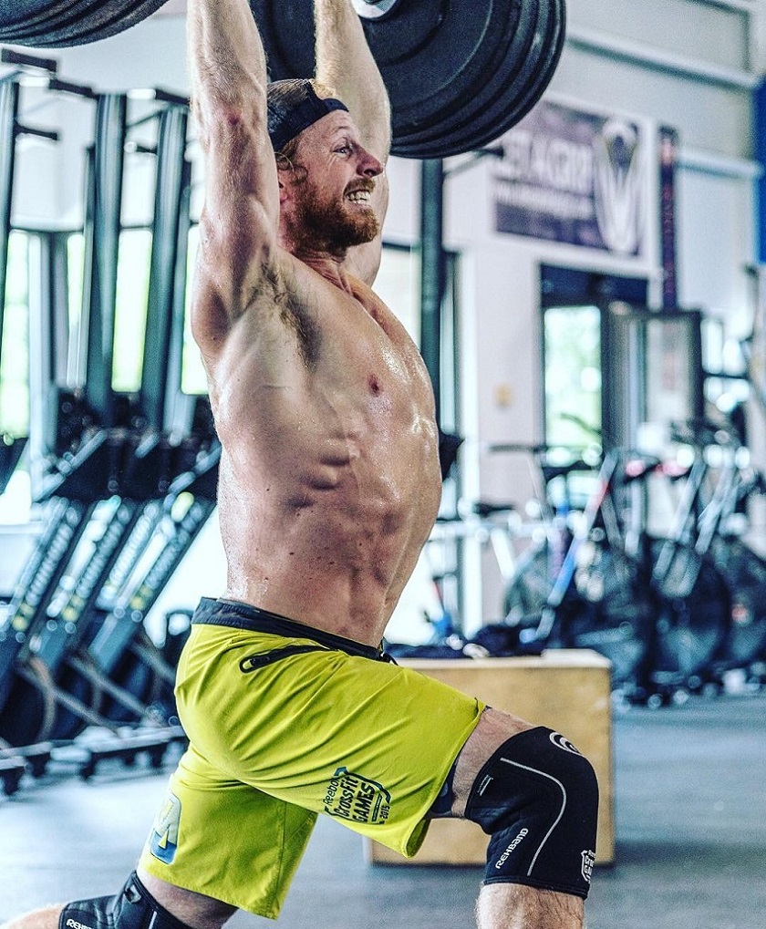 Graham Holmberg doing a heavy barbell overhead press