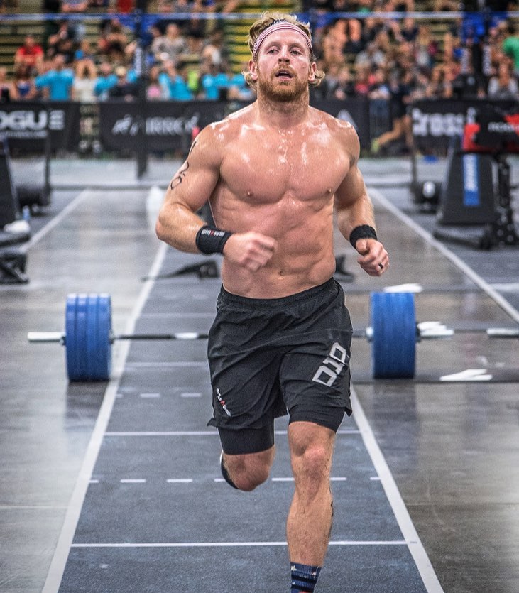 Graham Holmberg running shirtless during a CrossFit contest