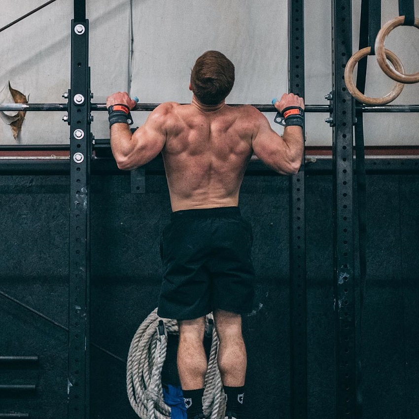 Noah Ohlsen doing pull ups while shirtless