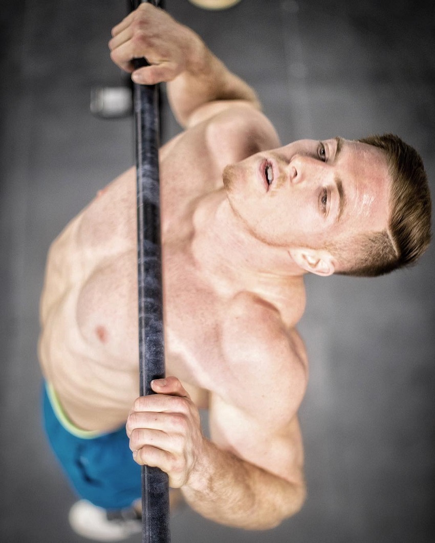 Noah Ohlsen doing pull ups while being shirtless