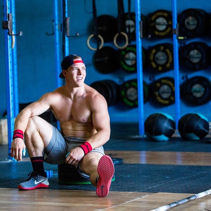 Noah Ohlsen sitting and resting on the floor during a training session