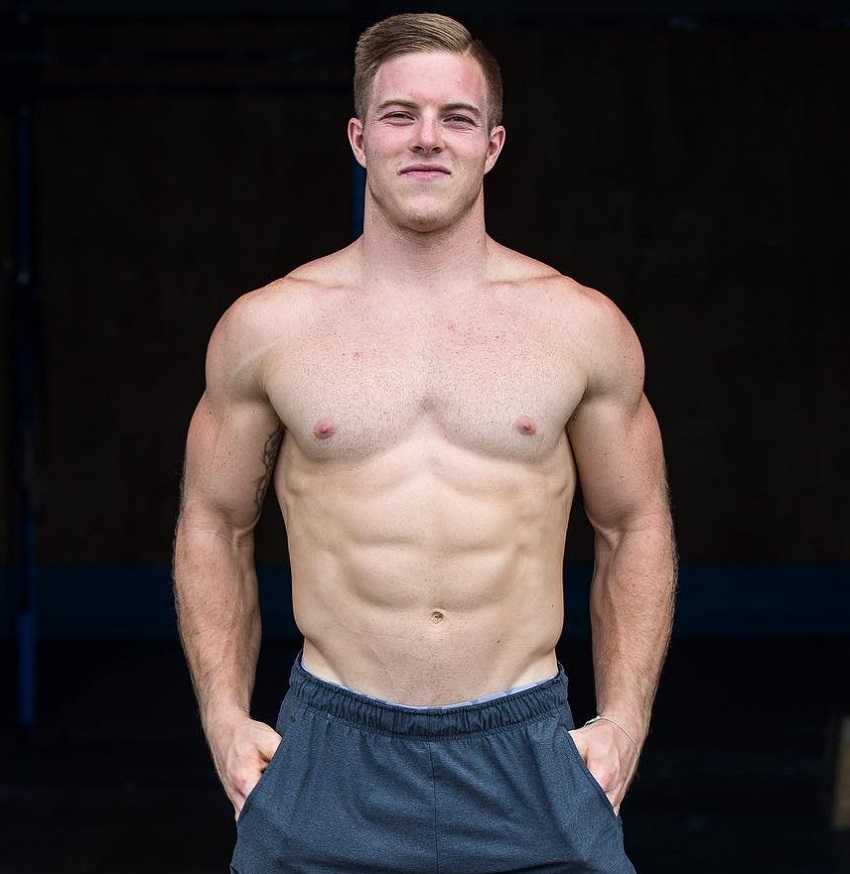 Noah Ohlsen posing shirtless for a photo looking fit and strong