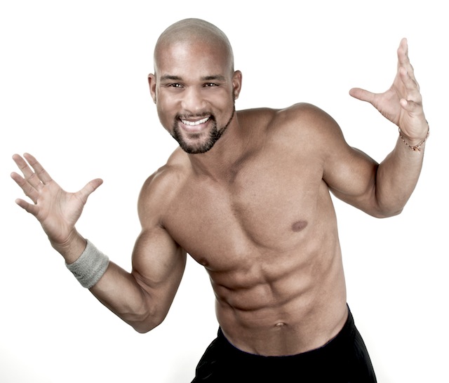 Shaun T posing shirtless in a professional fitness photo shoot