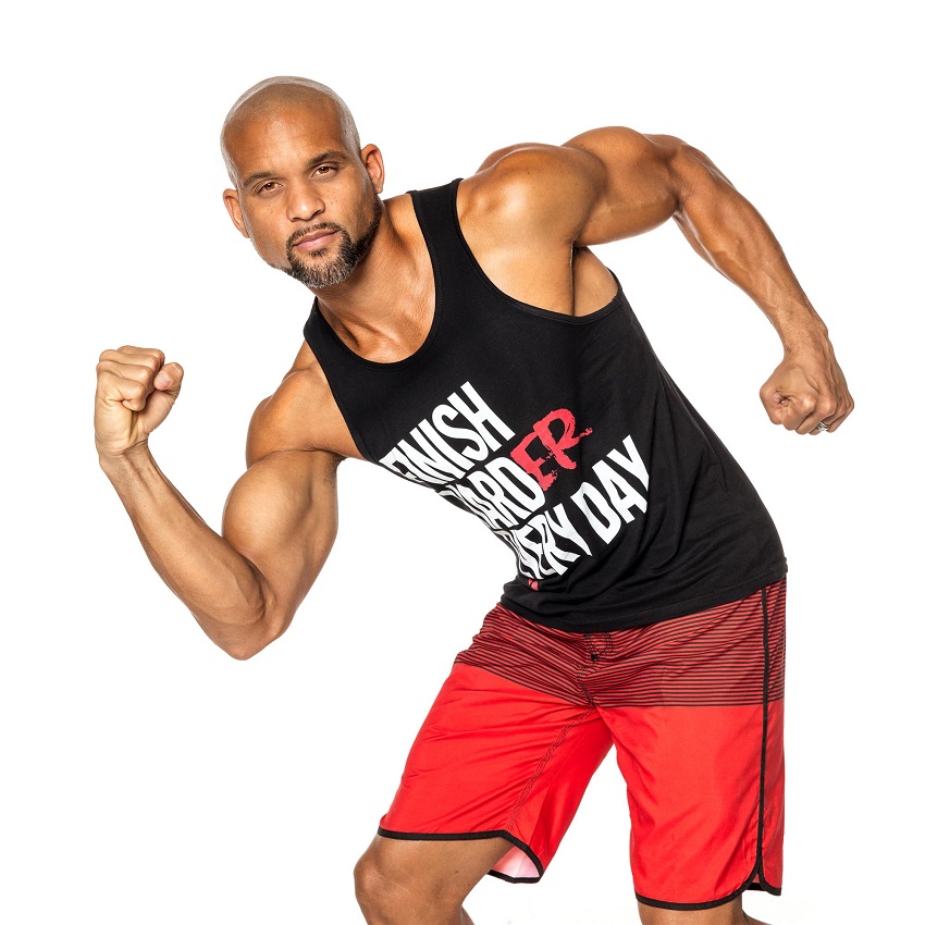 Shaun T posing in a professional photo shoot looking muscular and fit