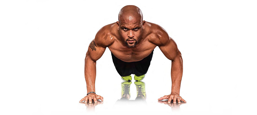 Shaun T doing pushups looking strong and fit