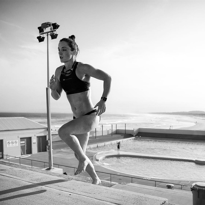 Tanya Poppett running up the stairs by the beach looking fit and strong