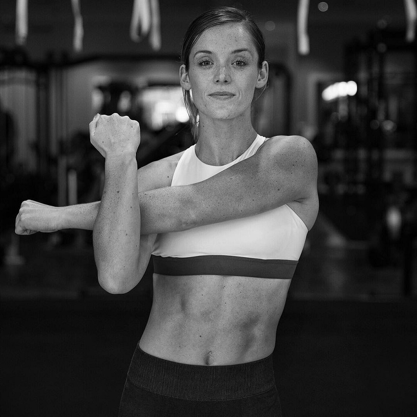 Tanya Poppett stretching her arms looking fit and lean