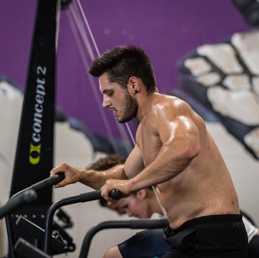 Travis Williams competing during a CrossFit event, looking fit and lean