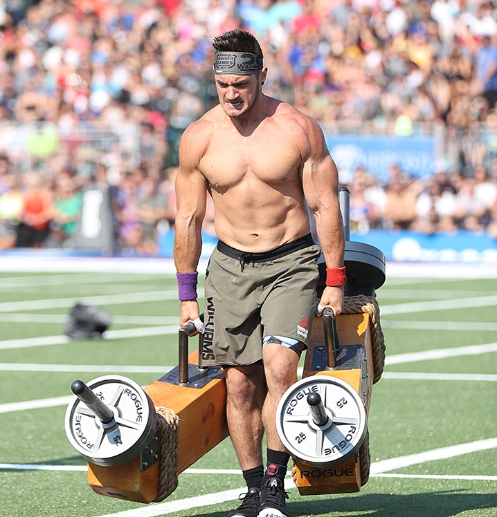 Travis Williams carrying heavy weights during a CrossFit competition