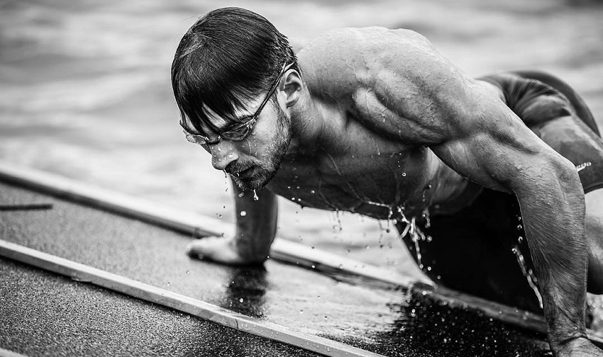 Alex Anderson getting out of a pool during a CrossFit competition