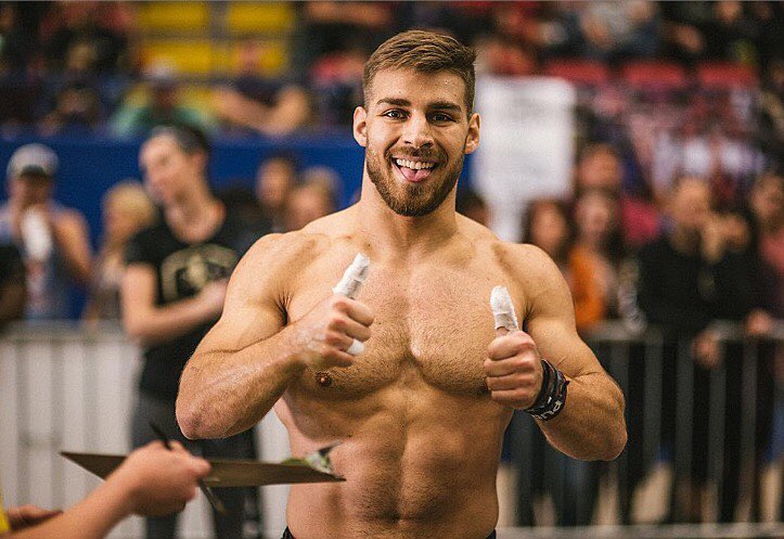 Alex Anderson pointing his thumbs up for the photo during a crossfit event, looking fit and strong