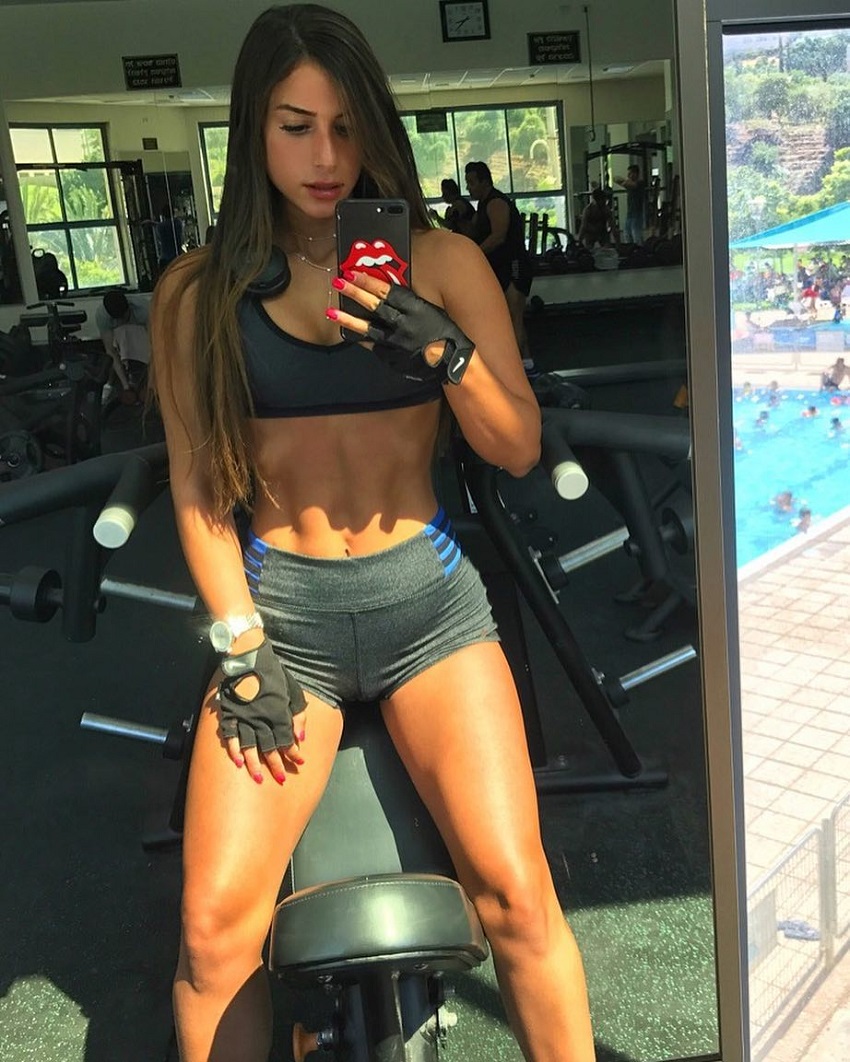 Avital Cohen taking a selfie of her toned and lean physique in a gym