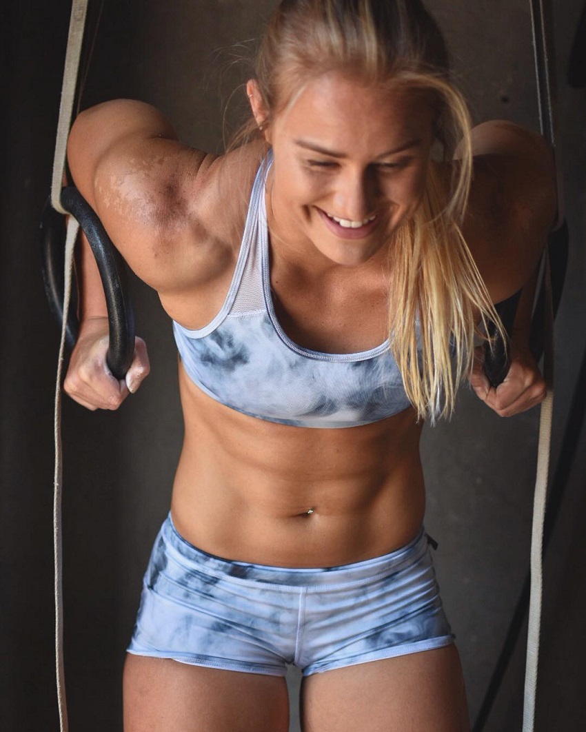 Dani Elle Speegle performing a ring exercise looking happy fit and healthy