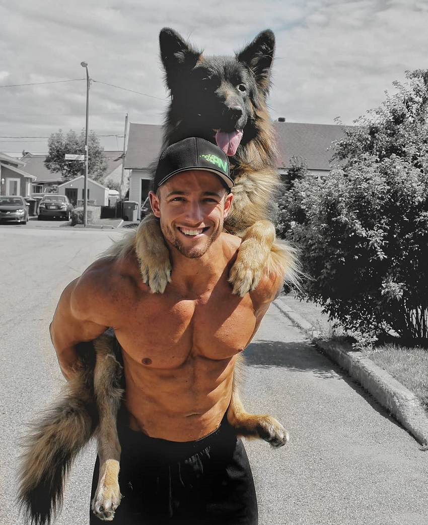 Jonathan Plante posing shirtless with his dog on his back