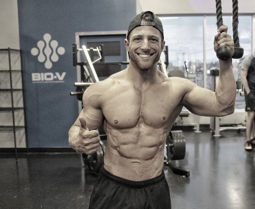 Jonathan Plante posing shirtless and smiling for a photo