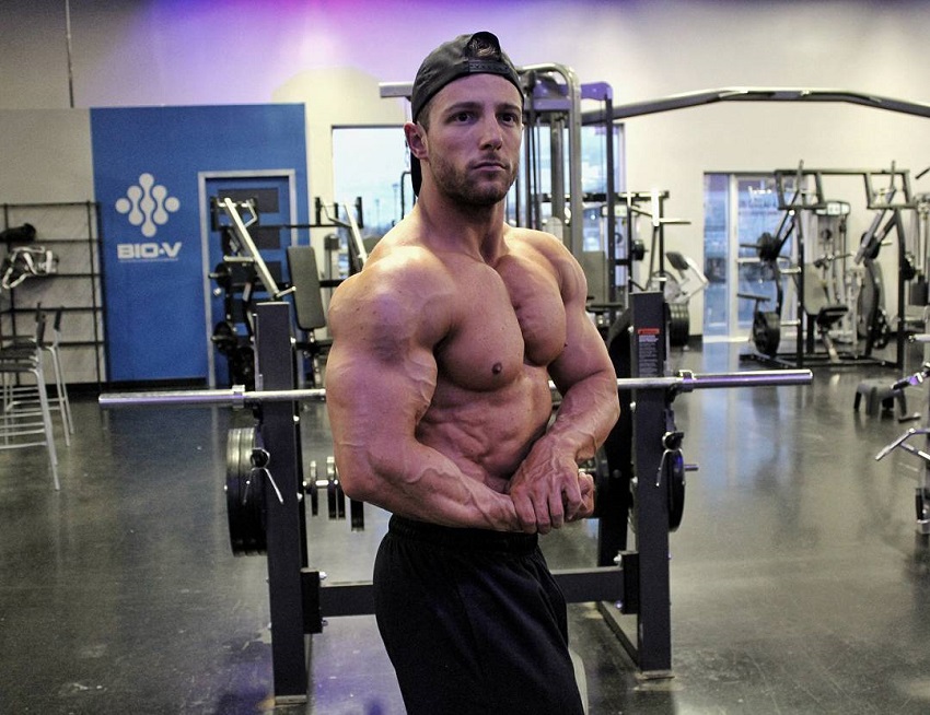 Jonathan Plante flexing shirtless in a gym