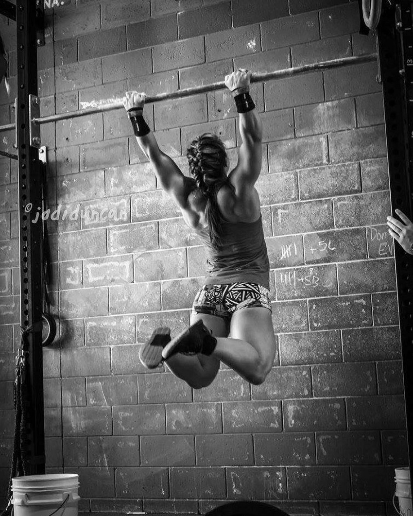 Kara Webb Saunders doing pull ups on a bar