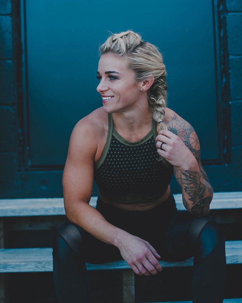 Lauren Herrera sitting and smiling looking muscular and fit