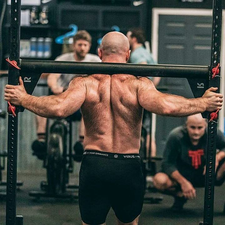 Lucas Parker carrying heavy weights on his back during CrossFit training