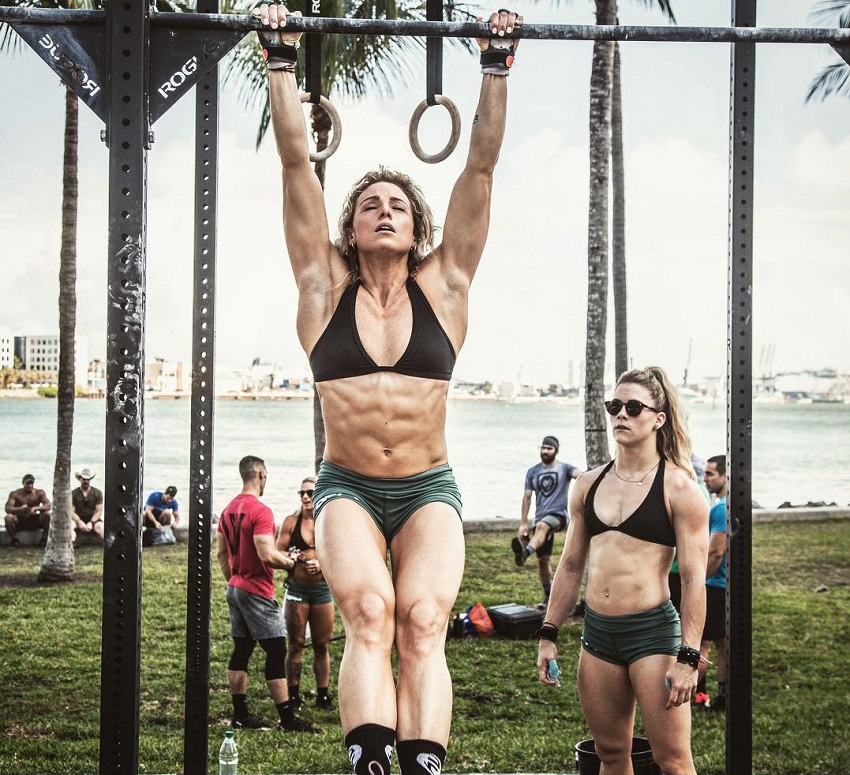 Tiffany Szemplinski performing hanging leg raises, looking fit and ripped