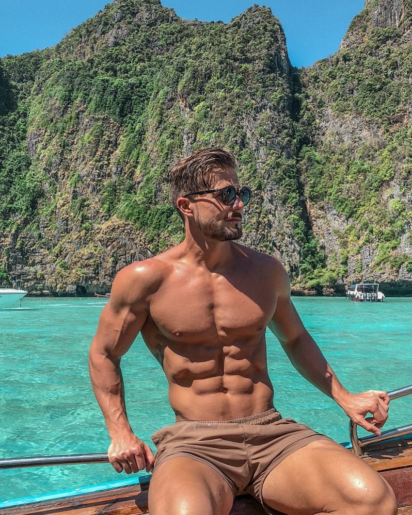 Antonio Pozo posing for a photo while sitting on a boat in an exotic blue sea