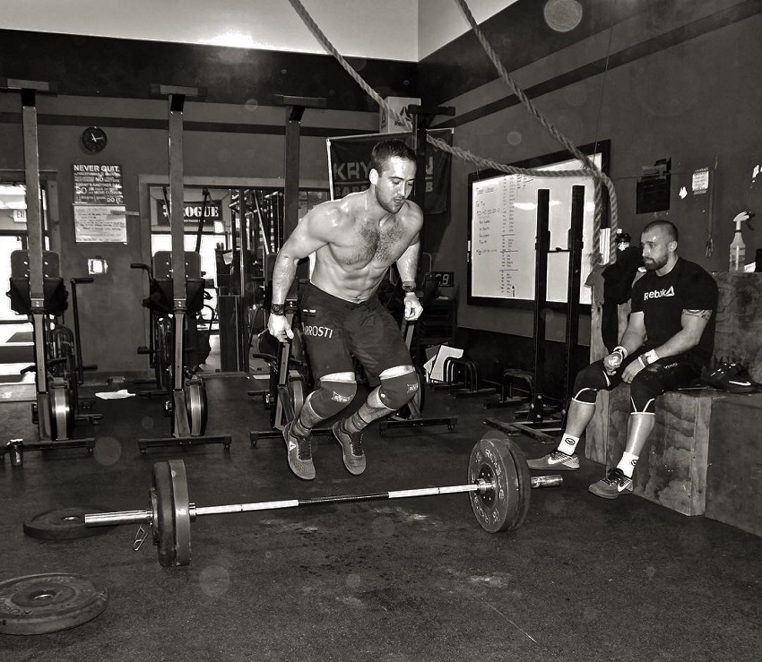 Ben Smith jumping over a barbell