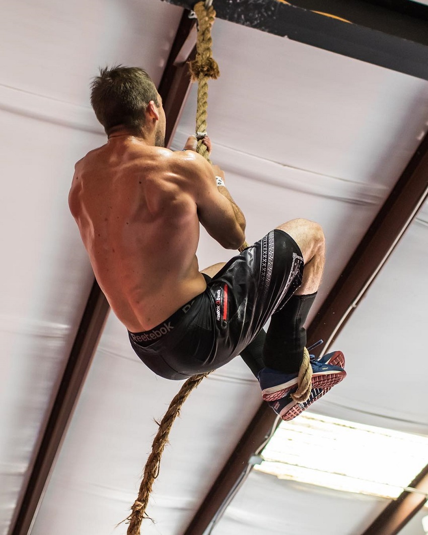 Ben Smith climbing rope shirtless