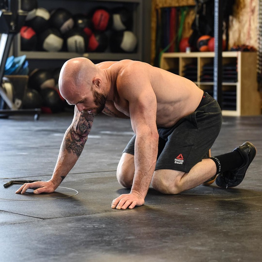 Chris Spealler preparing to do pushups looking strong and fit