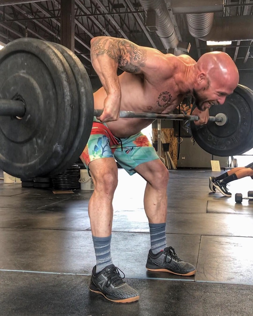 Chris Spealler doing heavy barbell rows looking fit and strong