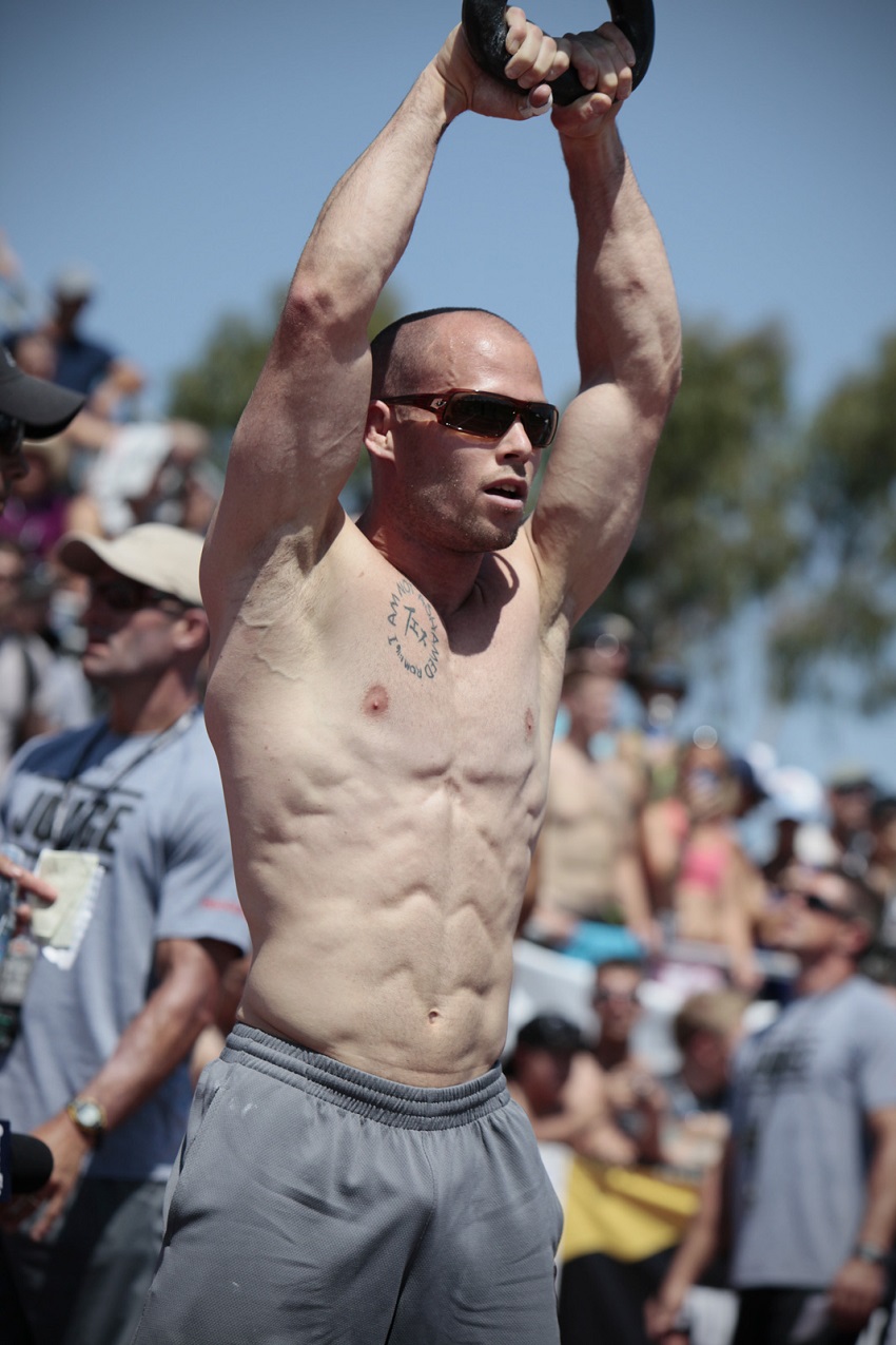 Chris Spealler performing an exercise shirtless during a CrossFit event