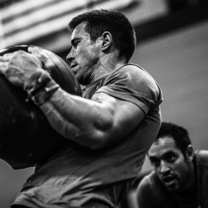 Dan Bailey lifting a heavy bag during crossfit workouts